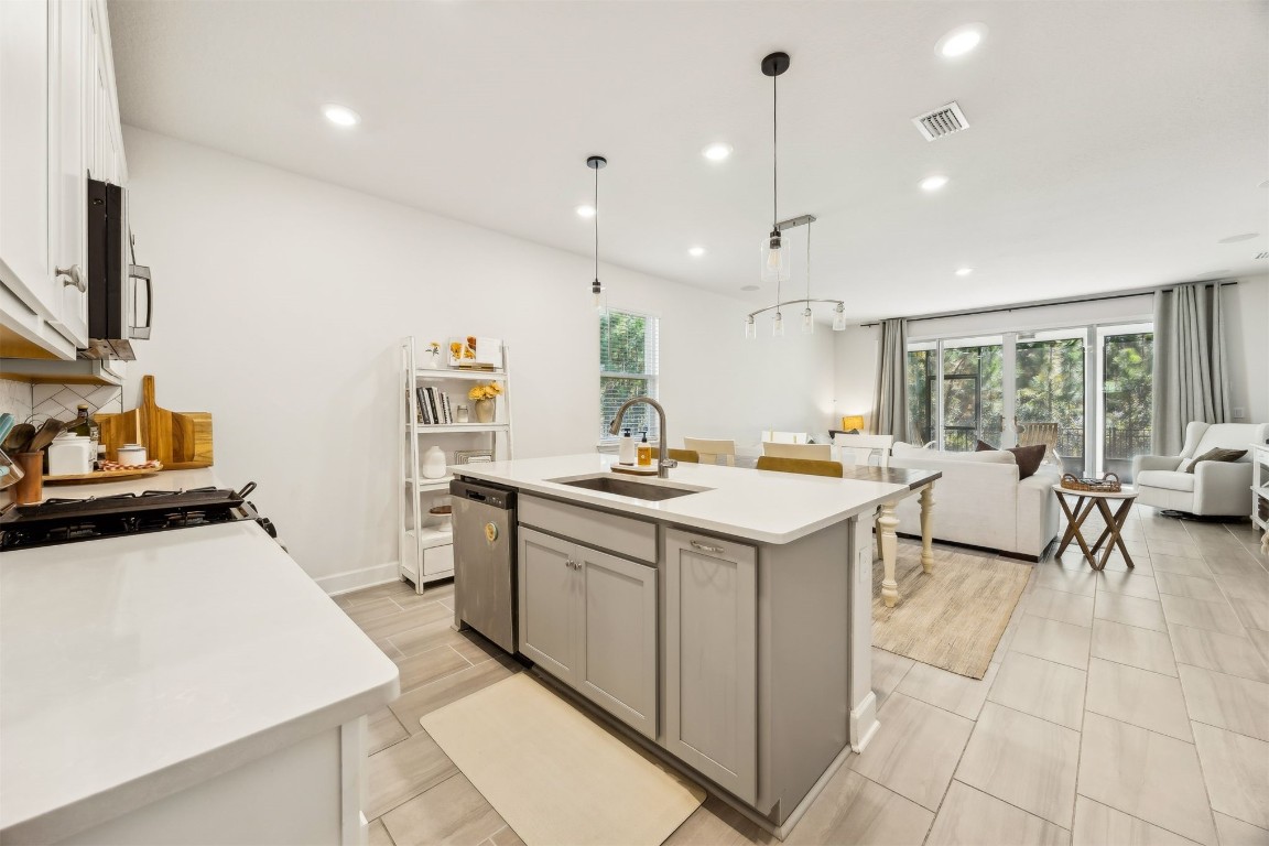 75968 Saffron Lane Yulee, FL 32097 - Photo 15 of 67 a kitchen with a sink and wooden cabinets
