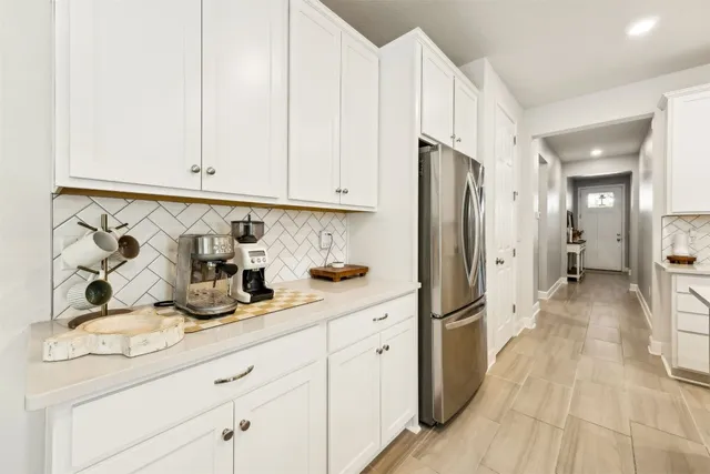 a bathroom with a granite countertop double vanity sink a mirror and a shower
