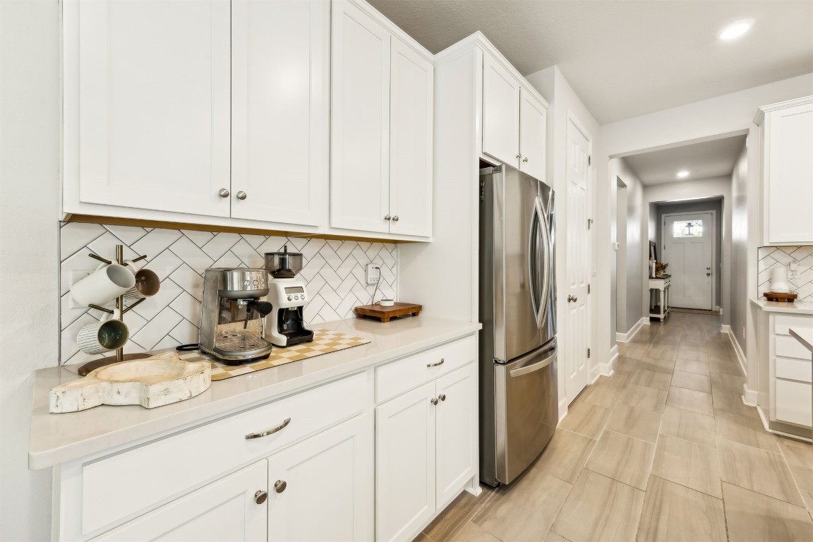75968 Saffron Lane Yulee, FL 32097 - Photo 18 of 67 a kitchen with stainless steel appliances granite countertop a refrigerator and white cabinets