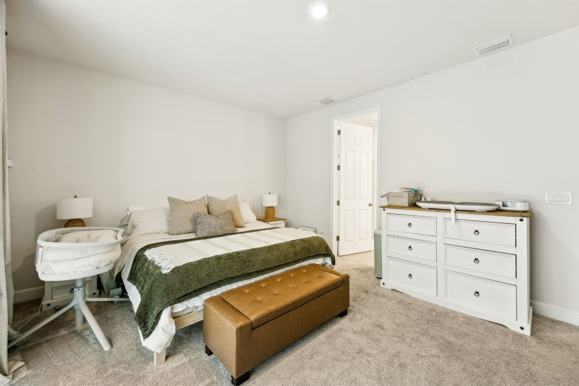 75968 Saffron Lane Yulee, FL 32097 - Photo 19 of 67 a bedroom with a bed and a chair