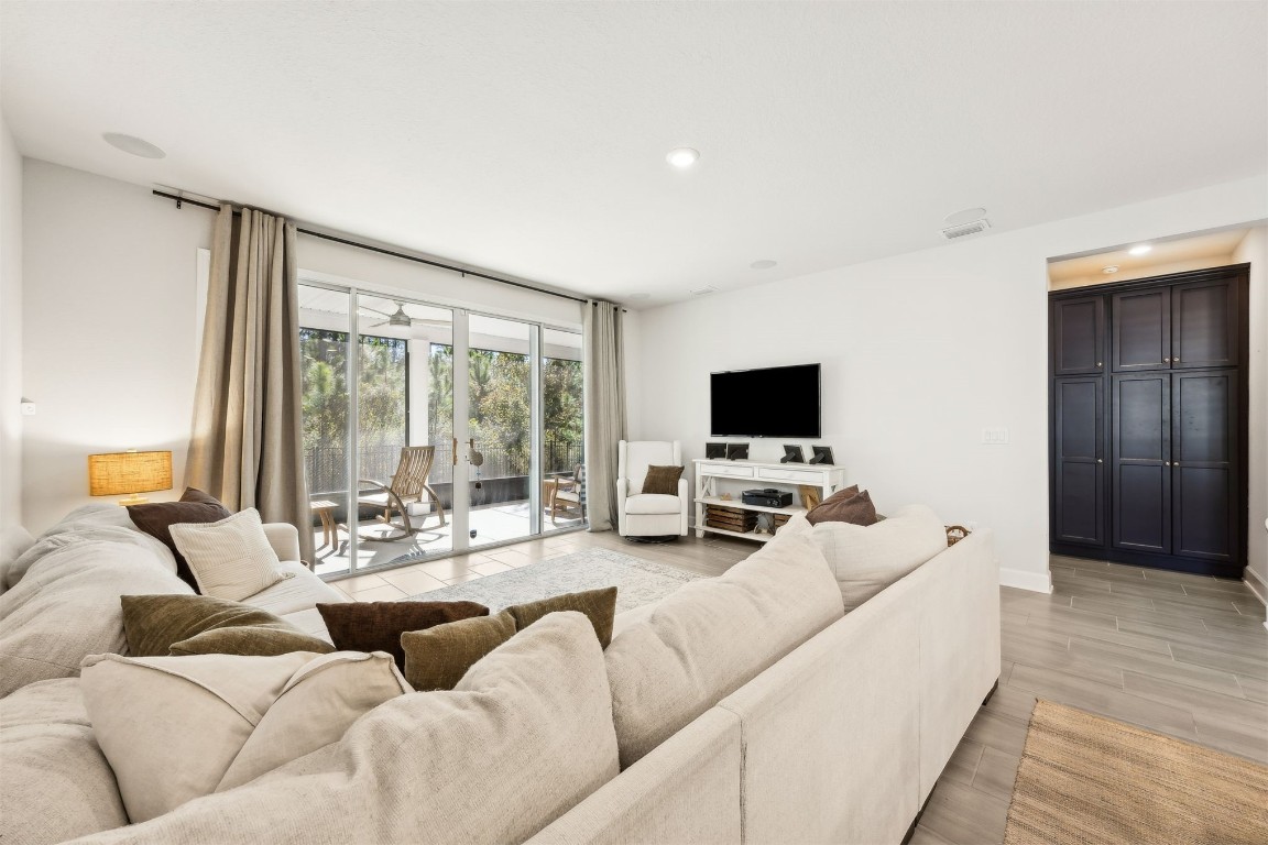 75968 Saffron Lane Yulee, FL 32097 - Photo 4 of 67 a living room with furniture flat screen tv and a large window