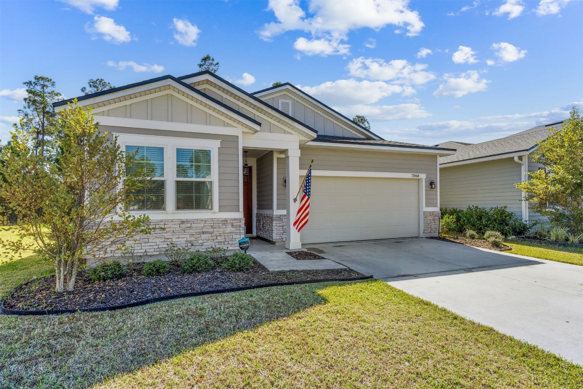 75968 Saffron Lane Yulee, FL 32097 - Photo 8 of 67 a front view of a house with a yard and garage