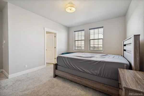 a bathroom with double sink large mirror and cabinets