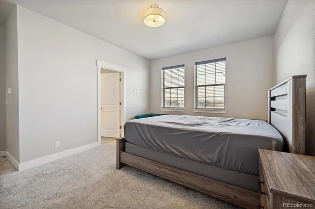 a bathroom with double sink large mirror and cabinets