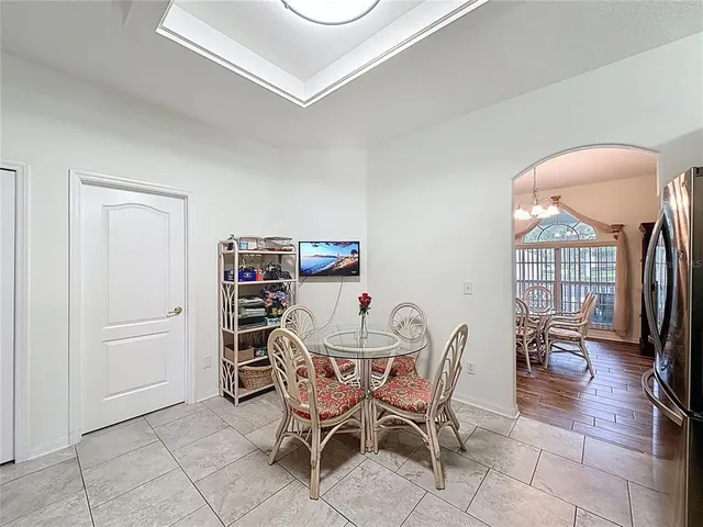 a view of empty room with wooden floor and ceiling fan