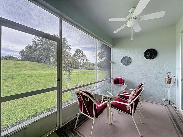 a view of a house with a yard and palm trees