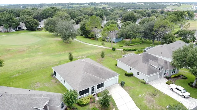 a view of a tennis ground with large trees
