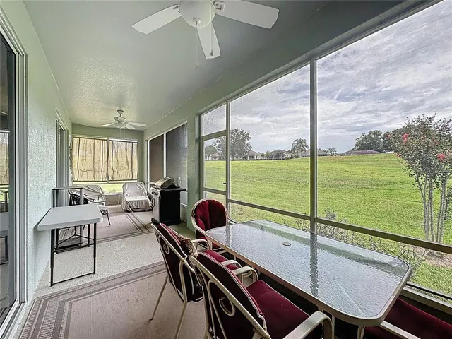 an aerial view of a houses with outdoor space and trees all around