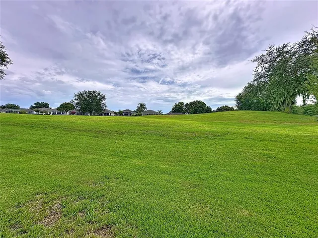 an aerial view of residential houses with outdoor space and swimming pool