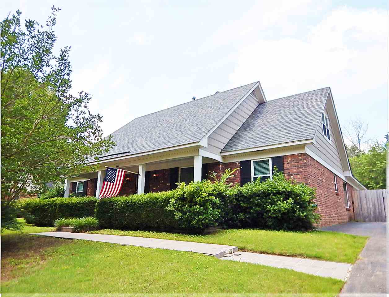 a front view of house with yard and green space