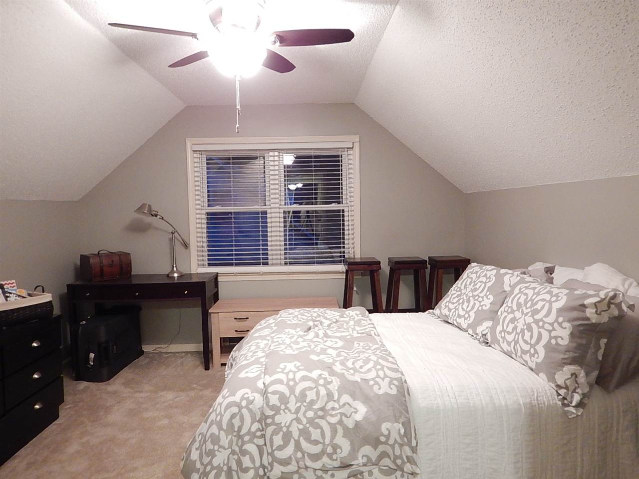 461 Dove Valley Road Collierville, TN 38017 - Photo 14 of 18 a bedroom with a bed and a chandelier