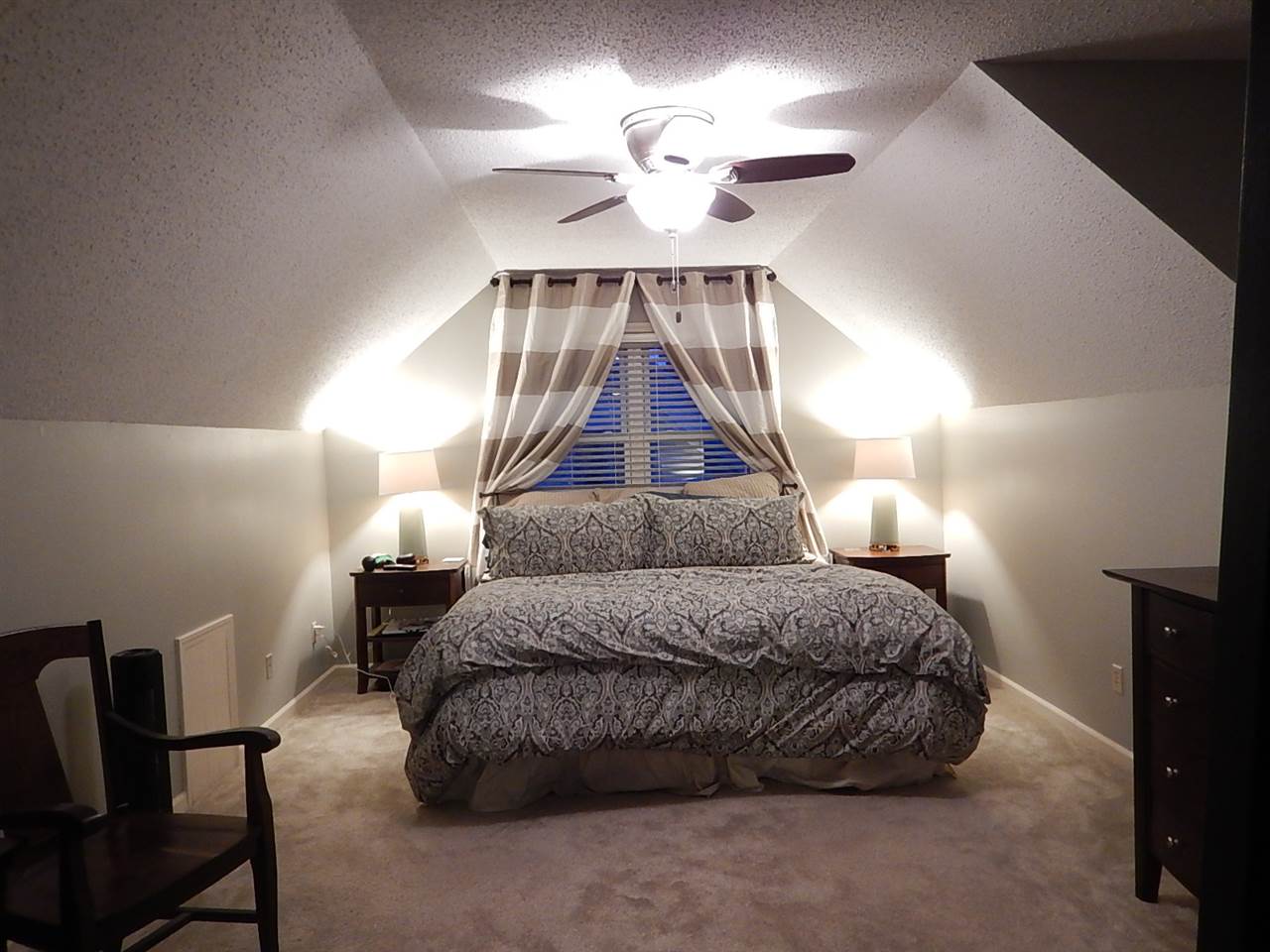 461 Dove Valley Road Collierville, TN 38017 - Photo 15 of 18 a spacious bedroom with a bed and a chandelier