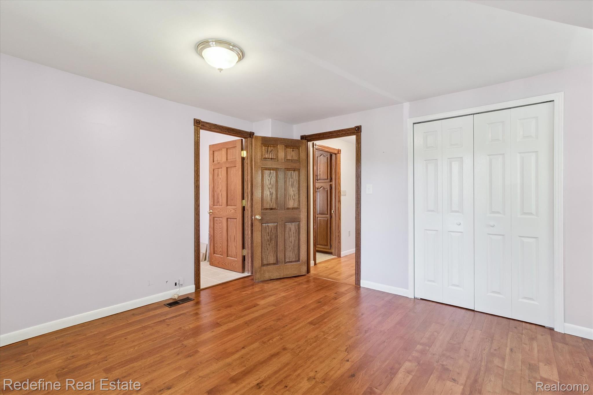 3777 Dorr Road Brighton, MI 48116 - Photo 44 of 77 Unfurnished bedroom featuring light wood-style flooring and a closet