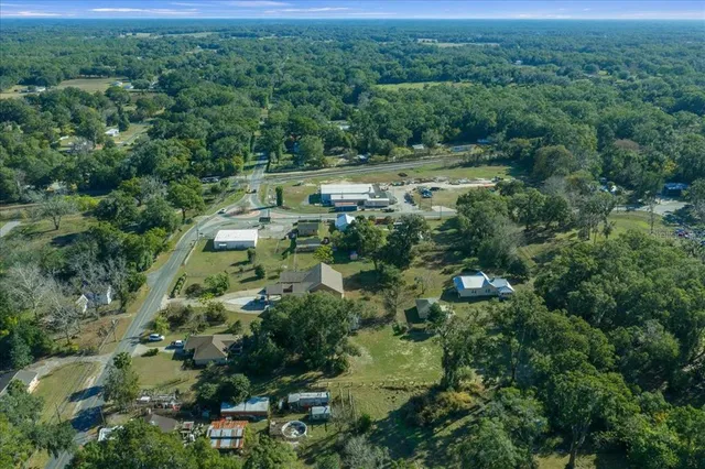 an aerial view of house with yard