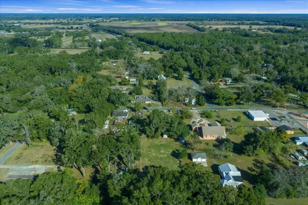 an aerial view of a house with swimming pool outdoor seating and yard