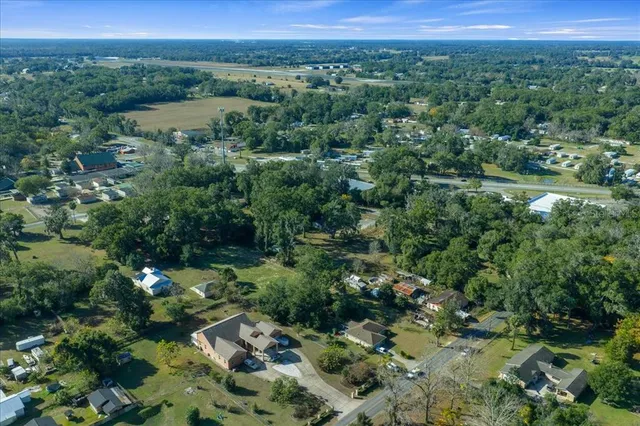 an aerial view of house with yard