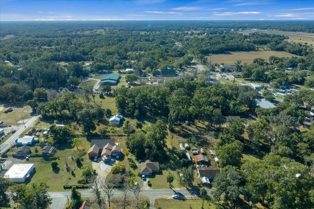 2026 Northeast 97th Street Road Anthony, FL 32617 - Photo 18 of 20 a view of a city with lush green forest