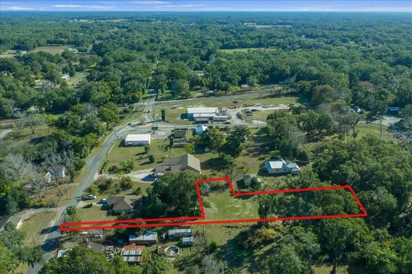 an aerial view of residential houses with outdoor space and street view