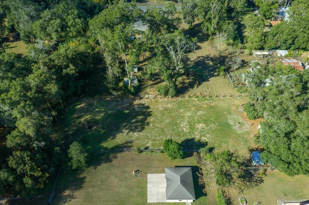 2026 Northeast 97th Street Road Anthony, FL 32617 - Photo 10 of 20 an aerial view of residential house with outdoor space and trees all around