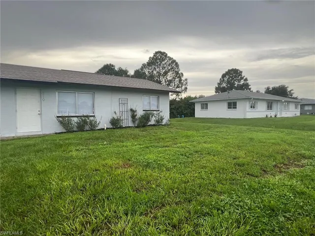 a view of a house with a back yard