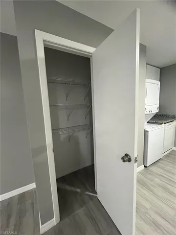 a view of walk in closet with wooden floor