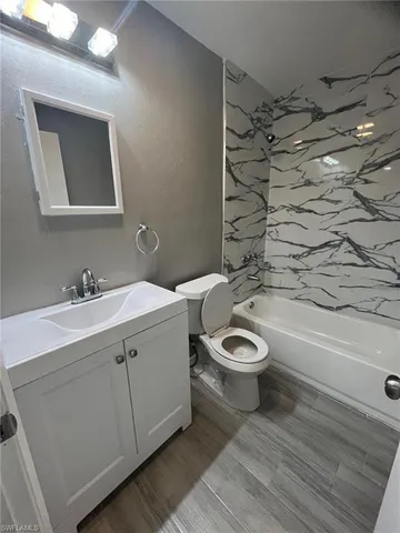 a bathroom with a toilet a sink and bathtub