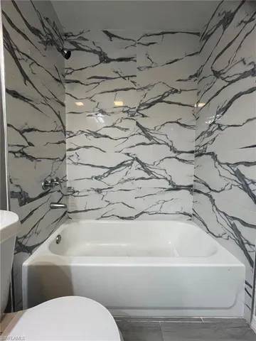 a bathroom with a bathtub and shower