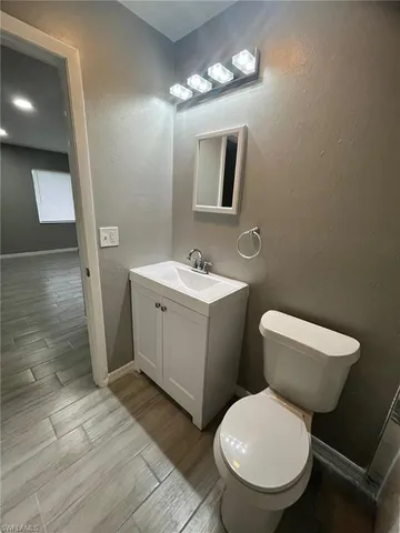 a bathroom with a toilet a sink and mirror