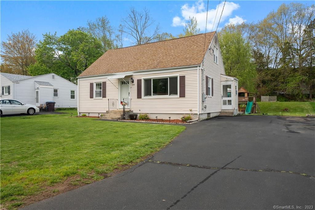 a white house with tree in front of it