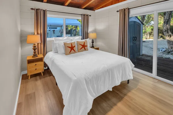 a bed sitting in a bedroom next to a window