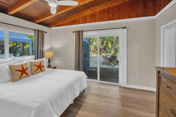 a bedroom with a large bed and a large window