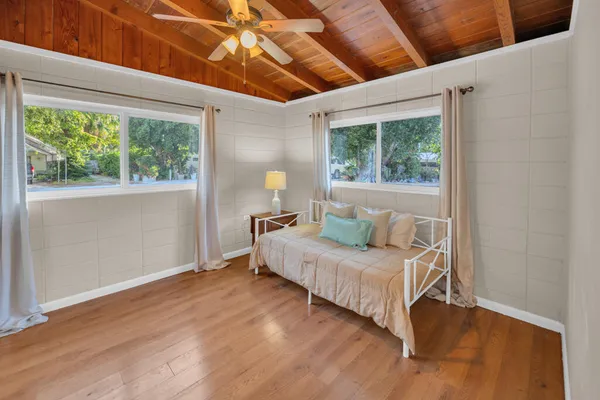 a bedroom with a bed and a large window