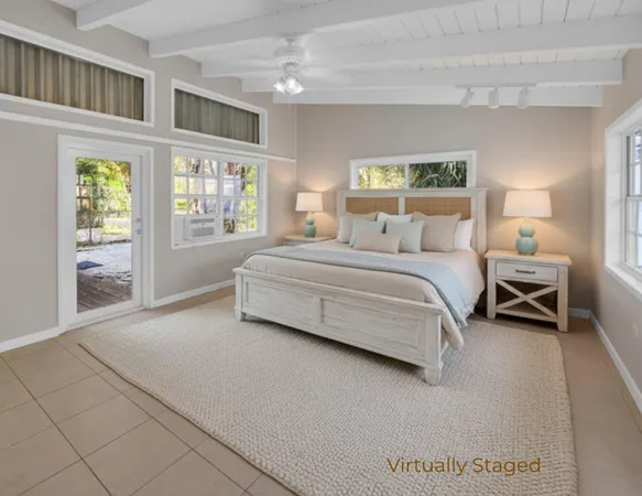 a spacious bedroom with a bed and a large window