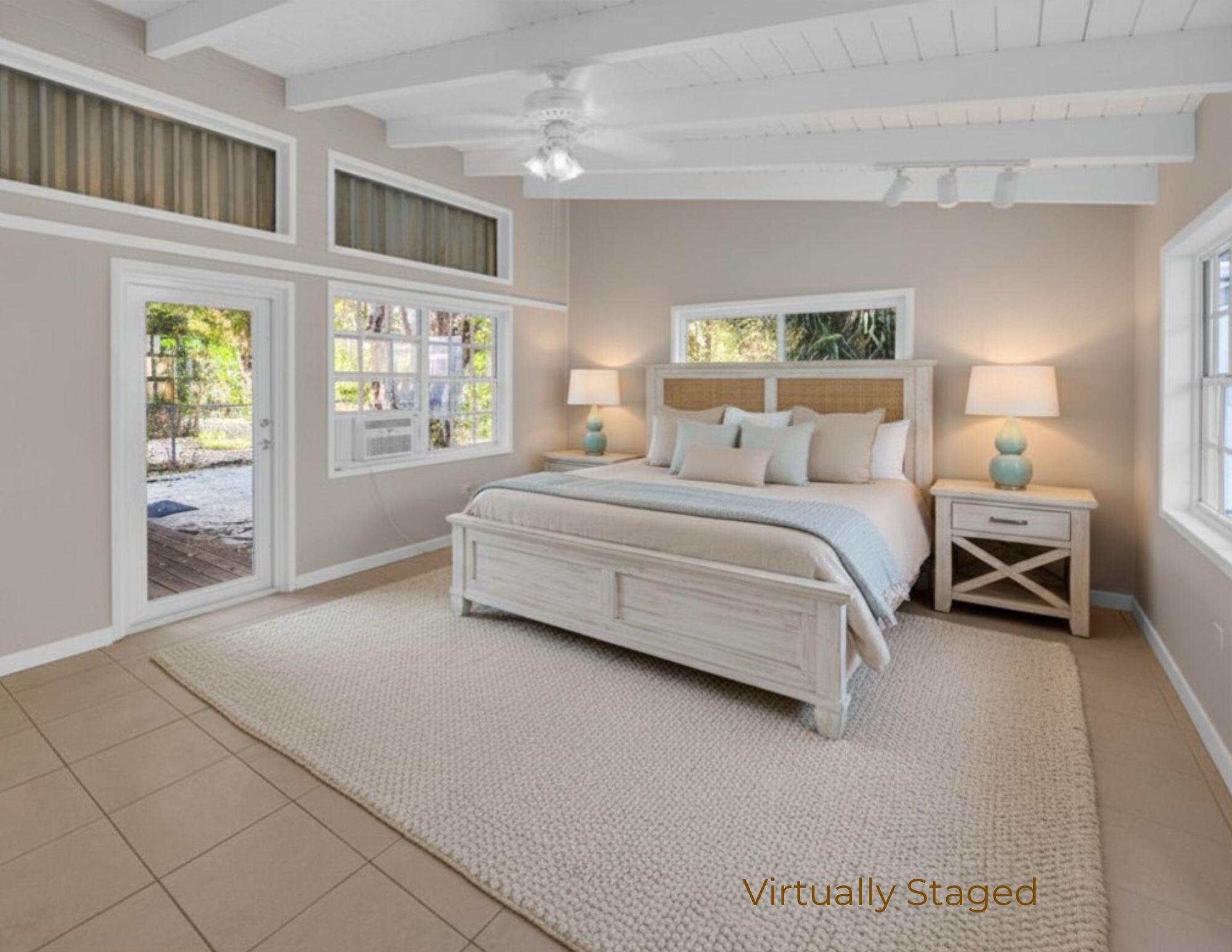 124 South Hammock Road Islamorada, FL 33036 - Photo 7 of 23 a spacious bedroom with a bed and a large window