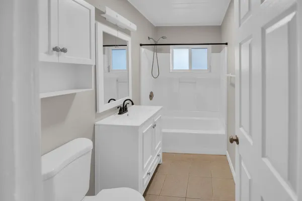 a bathroom with a bathtub a sink a toilet and a mirror