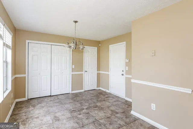 a view of a kitchen with a refrigerator and a stove top oven