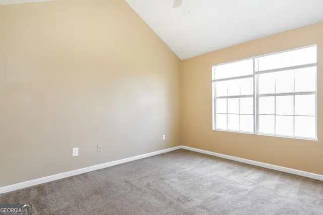 a bathroom with a granite countertop sink mirror vanity and toilet