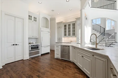 a view of a hallway with windows and furniture