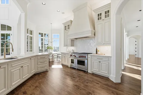 a kitchen with stainless steel appliances granite countertop a sink and dishwasher with wooden floor