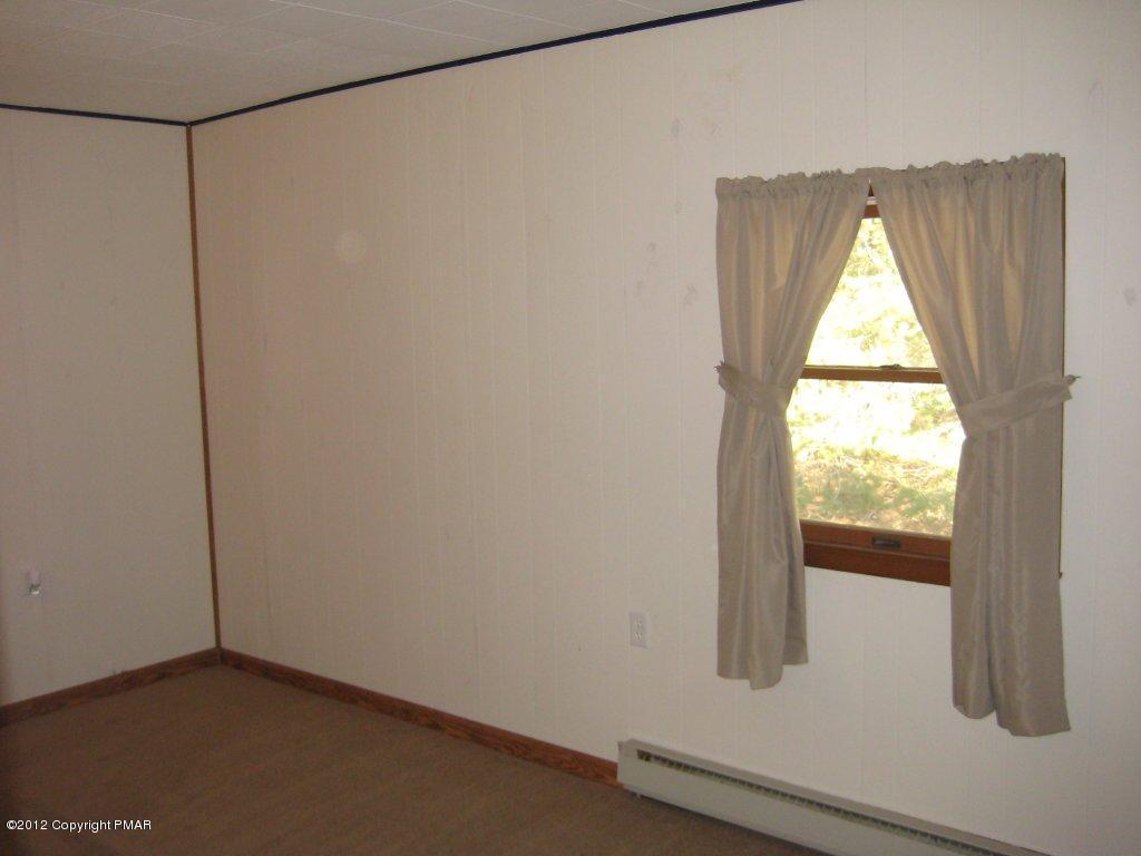 105 Westbrook Road Effort, PA 18330 - Photo 5 of 12 a view of empty room with wooden floor and fan