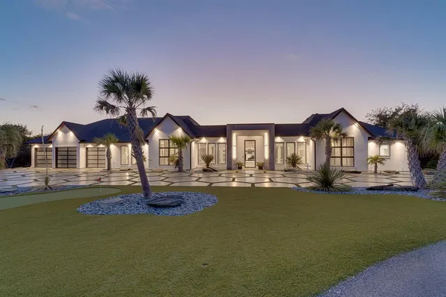a front view of a house with swimming pool having outdoor seating