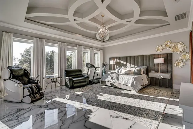 a bedroom with furniture and a large window