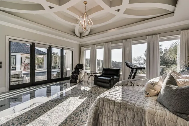 a bedroom with a large bed and a large window