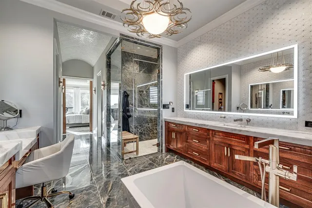 a spacious bathroom with a granite countertop sink mirror and bathtub