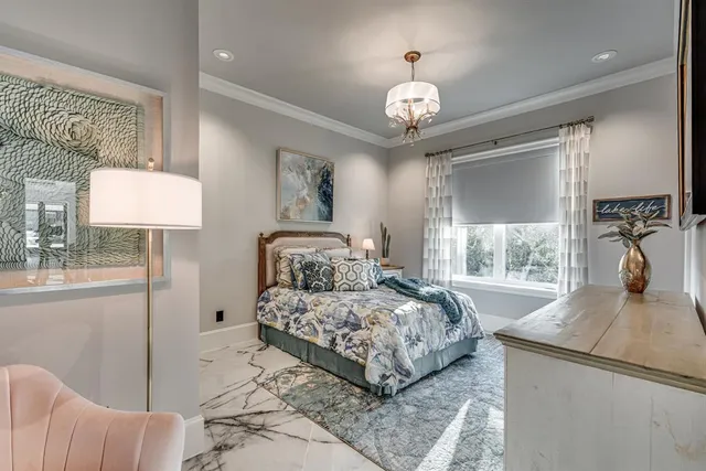 a bedroom with a bed and a chandelier