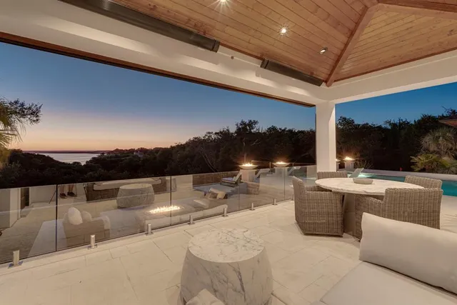 a view of roof deck with couches and sky view