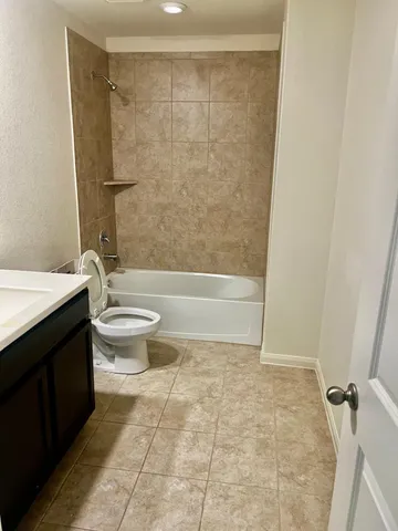 a bathroom with a toilet a sink and shower