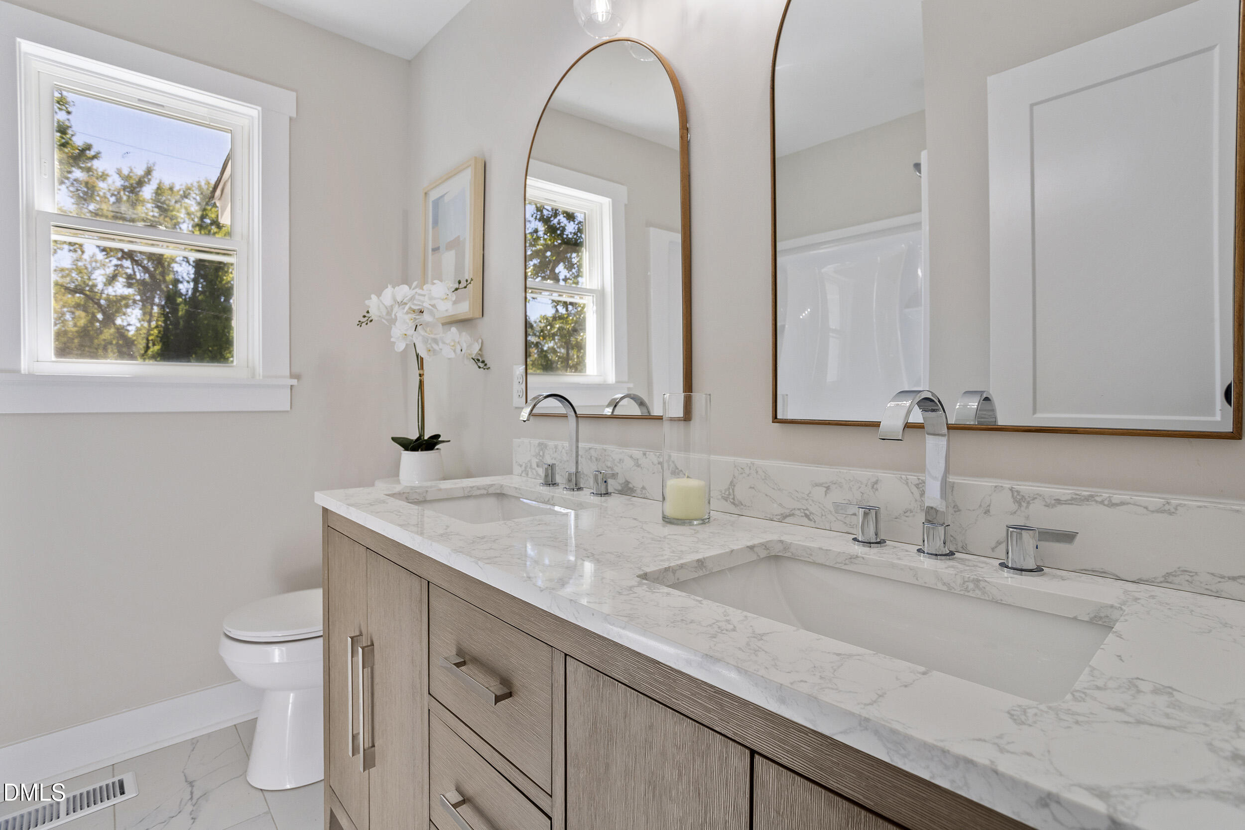 1311 Castlebay Road Durham, NC 27704 - Photo 24 of 39 a bathroom with a granite countertop toilet sink and mirror