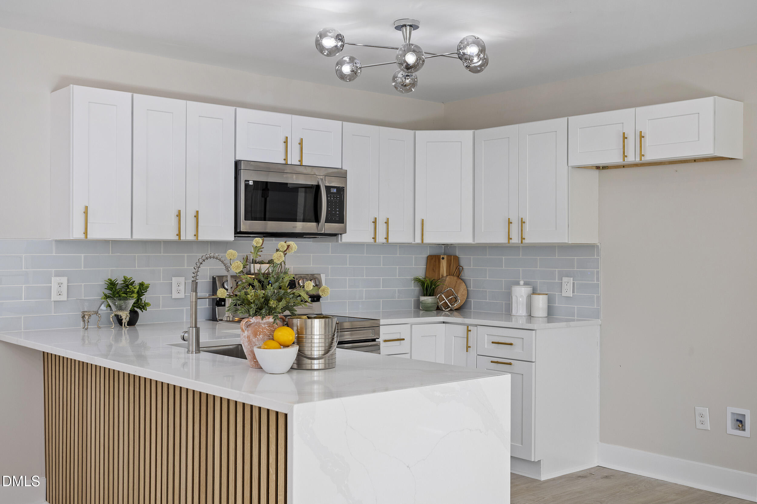 1311 Castlebay Road Durham, NC 27704 - Photo 2 of 39 a kitchen with a sink a microwave and cabinets