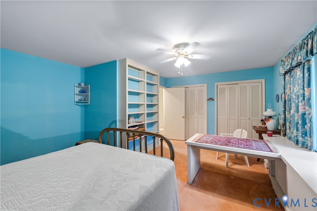 2086 Defense Road Petersburg, VA 23805 - Photo 25 of 32 Carpeted bedroom with two closets and ceiling fan